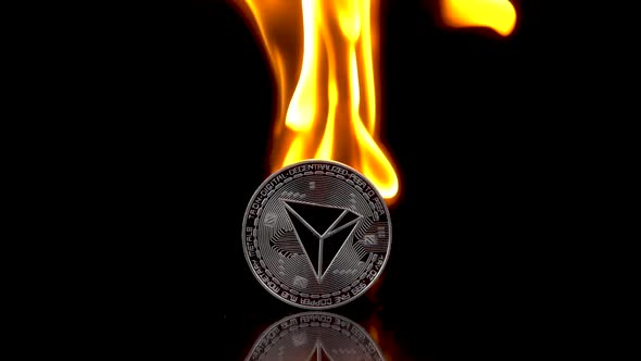 Tron  TRX Coin Catches Fire on an Isolated Black Background