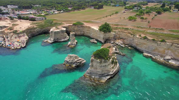 4K aerial of the rock formations of Sant'Andrea near Torre Dell'Orso, Apulia, Italy in the summer.