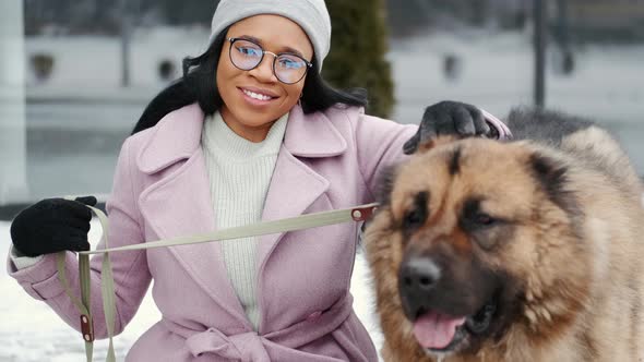 Woman Walking Cute Dog Outdoors on Winter Day