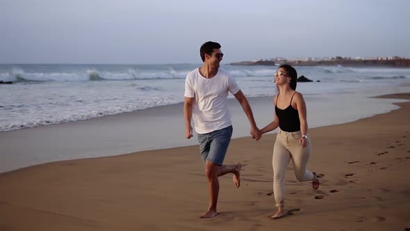 Couple Enjoy Summer Vacation on the Large Beach Enjoy Life and Running in Scenery Slow Motion Video