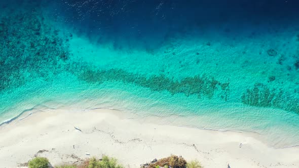 Aerial drone travel of idyllic lagoon beach adventure by blue sea with white sandy background of a d