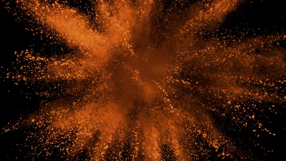 Orange powder exploding on black background in super slow motion, shot with Phantom Flex 4K