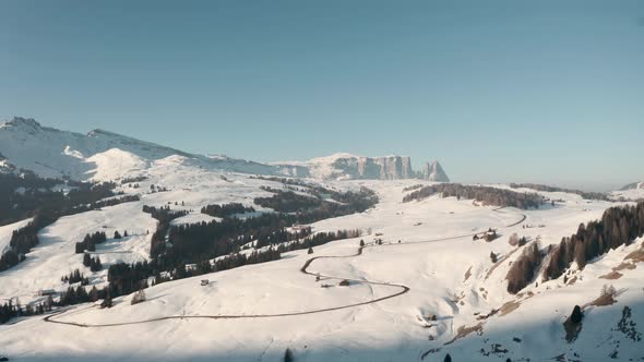 Dolly forward drone shot towards mountain road in seiser alm Italian dolomites