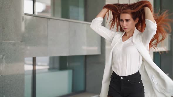 Beautiful confident business woman with red hair walk work near office