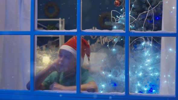 Sleepy Dreaming Boy Looking in Window in Christmas Time