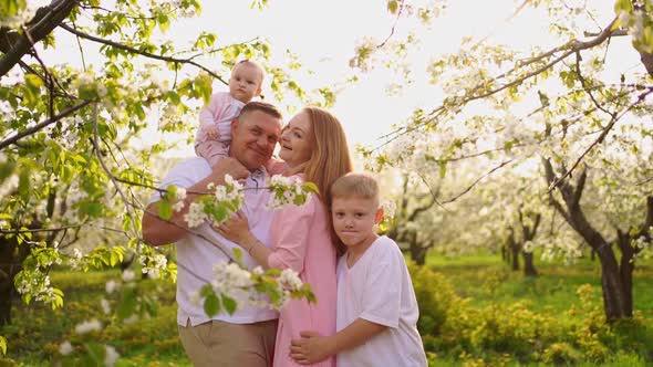 Family with Son and Daughter in Spring Flowering Garden