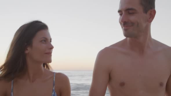 Young adult couple relaxing at the seaside