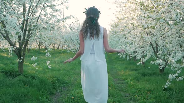 girl walking on a blooming garden and resting