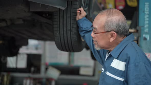 Wheel automobile technician man maintenance, Male mechanic checking and repair car garage service.