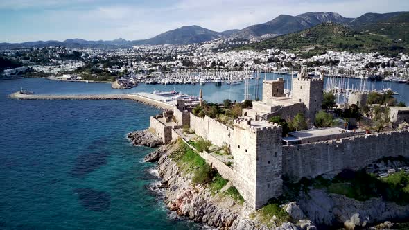 View from drone on full of yachts Bodrum harbour and ancient Kalesi castle in Mugla in Turkey