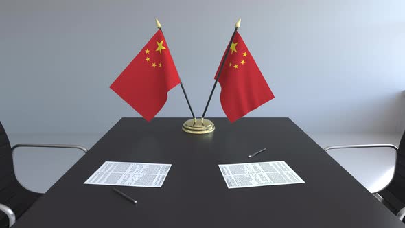 Flags of China and Papers on the Table