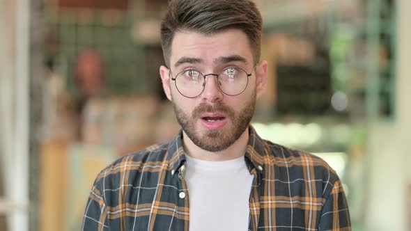 Portrait of Upset Young Man Feeling Shocked