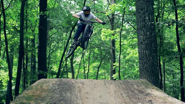 Slow Motion of a Bicycle Rider Jumping Over a Natural Ramp