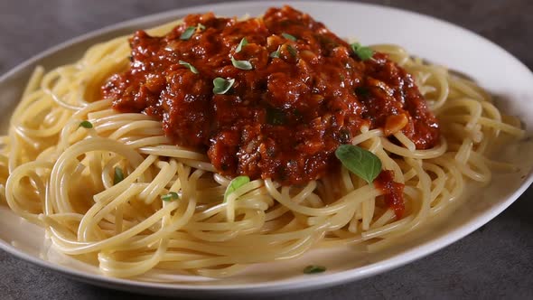 Spreading oregano leaves over spaghetti