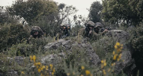 Israeli soldiers in a surveillance and reconnaissance mission using binoculars