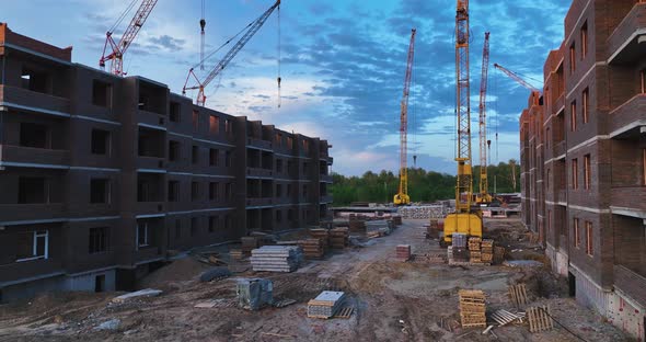 Construction site of low-rise brick houses in summer. Aerial view