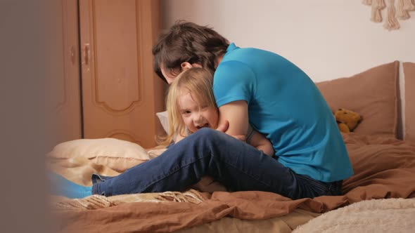 Dad and Daughter Play in Bedroom Happy Family on Bed