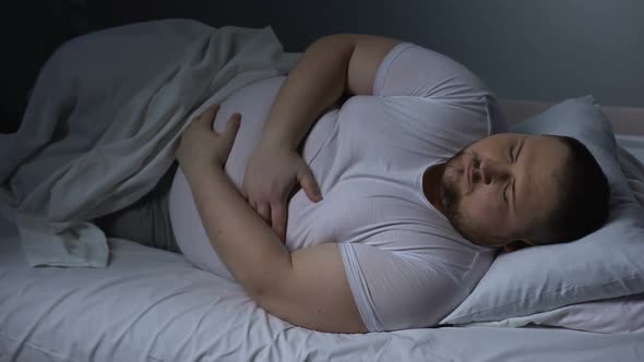 Fat Man Suffering From Stomach Pain at Night, Health Problem, Ulcer Discomfort