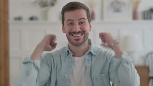 Portrait of Excited Young Man Celebrating Success