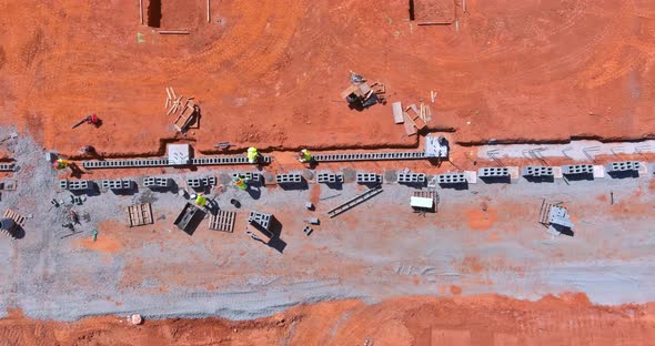 A Mason Man is Laying the Mounting a Wall of Aerated Concrete Blocks