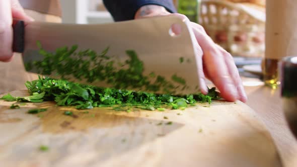 Close-Up Shot of Cutting Parsley with Butcher Knife