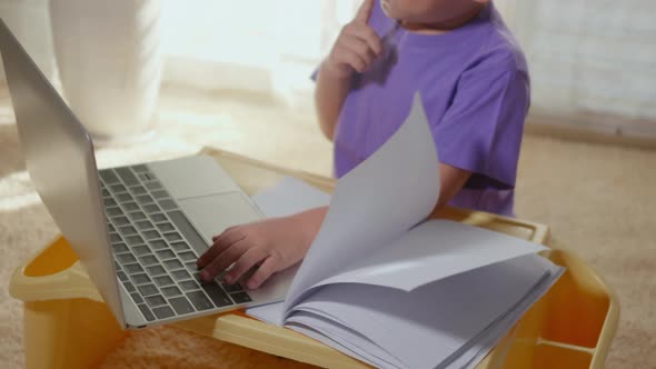 child boy using a laptop study online lesson at home