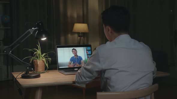 Man Using Laptop Talk To Colleagues In Video Call Meeting, Working From House