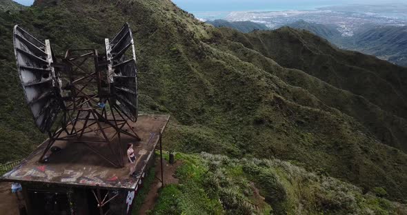 Drone 4000ft up in the air in Oahu getting a shot of a girl with her hands up while standing on a sa