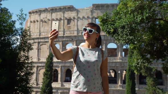 Young Woman Taking Selfie Near Colosseum in Rome