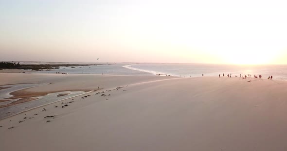 Aerial drone view of a group of people crowd on a sand dune at the beach