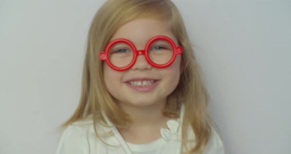 Funny Little Child Girl Wear Red Glasses Holding Stethoscope Playing Game As Doctor, Happy Cute