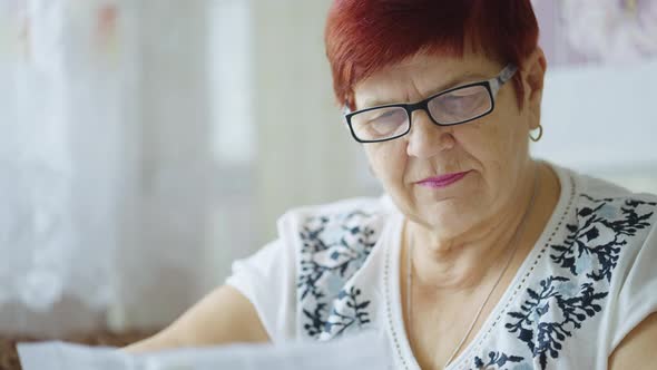 Senior Woman in Eyeglasses Reading Instruction To Drugs