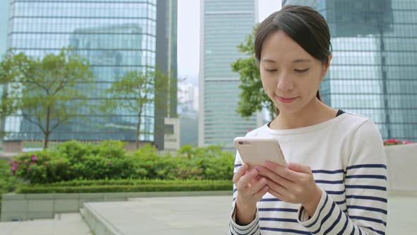 Woman use of cellphone at central of Hong Kong