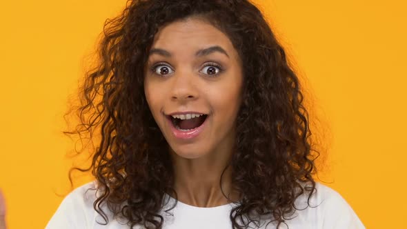 Excited African-American Woman Impressed by Good News, Wow Gesture, Positivity