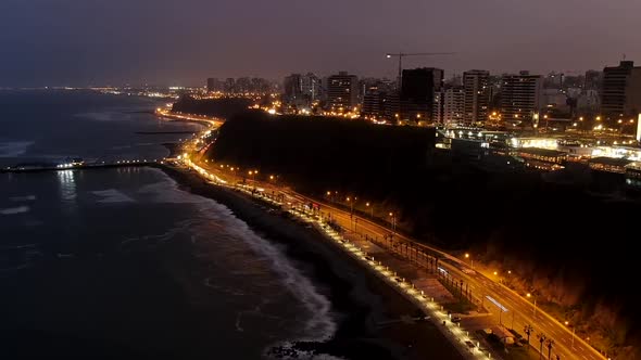 Vehicles Traveling In Coastal Road At Night Near La Rosa Nautica Restaurant In Miraflores, Lima, Per