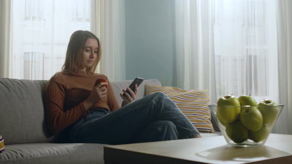 Young Girl with Red Apple and Phone