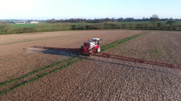 Tractor Spraying Fields on an Arable Farm with Glyphosate Herbicide