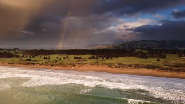 Coast with rainbow and stormy clouds