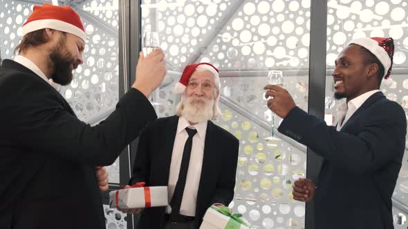 Male Business Colleagues with Glasses of Champagne Having Celebration at Office Party