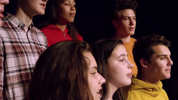 Teenagers rehearsing in a theatre alt