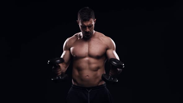 Fit and sporty bodybuilder over black background.