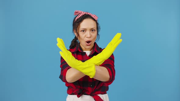 Emotional Housewife in Rubber Gloves Crossing Hands in Rejection Blue Studio Background