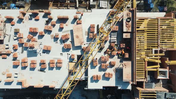 Aerial Top View on the Construction of a Multistorey Red Brick House