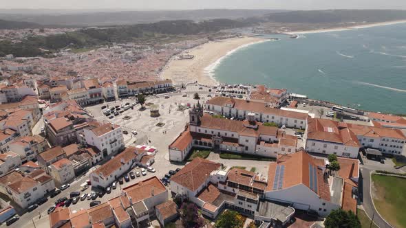 Sprawling white sand beach of Nazare, seaside resort town, Portugal. Panoramic aerial view