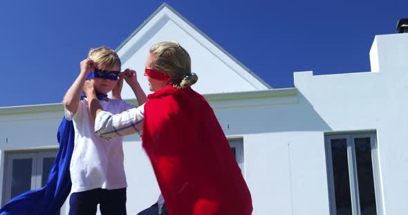 Smiling mother and son pretending to be superhero 4k