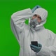 Doctor Wearing a PPE Suit Uniform Face Shield Mask and is Holding a Phone and Searching He is - VideoHive Item for Sale