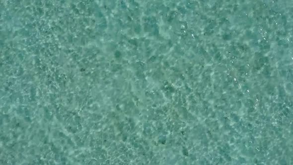 Aerial drone sky of island beach break by blue ocean with sand background