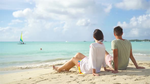 Young Couple on Tropical Beach with White Sand and Turquoise Ocean Water at Antigua Island in