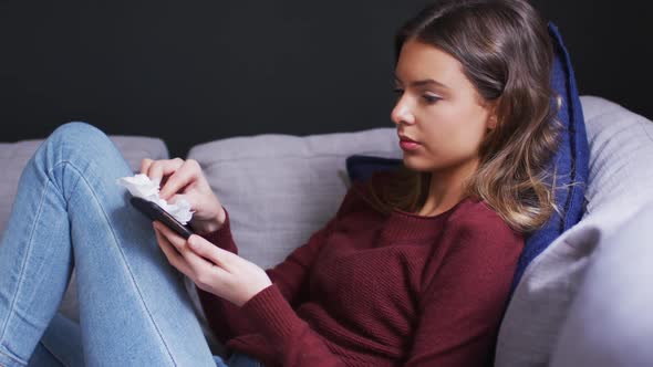 Woman wiping her smartphone with a tissue