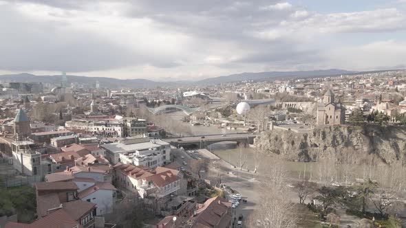 Aerial view of Metekhi church in old Tbilisi located on cliff near river Kura. Georgia 2021 Spring